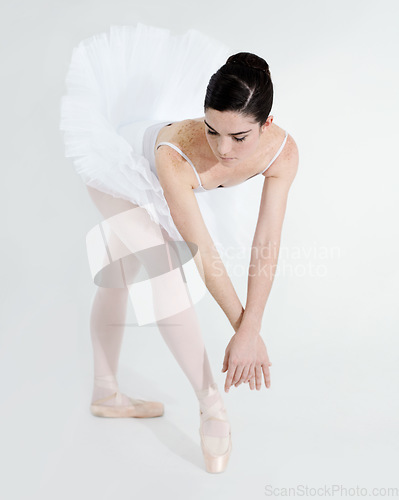 Image of Art, dance and ballet with a woman in studio on a white background for rehearsal or recital for theatre performance. Training, creative and flexible with a young female ballerina or dancer in uniform