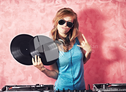 Image of DJ woman, mixer and portrait with vinyl records, sunglasses and horns sign at club, studio or party. Girl, music director and party with rock icon, turntable or attitude for event, celebration or job