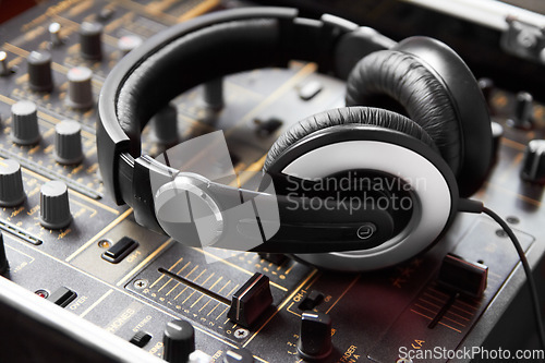 Image of Headphones, mixer and sound engineering equipment in a recording studio for music production closeup. DJ, control and creative with audio technology from above to produce for radio broadcasting