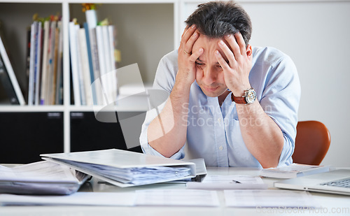 Image of Head, business and man with stress, tired and fatigue with a new project, documents and chaos. Male person, employee and architect with mental health issue, depression and migraine with paperwork