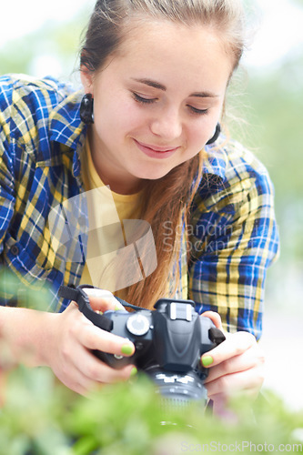 Image of Woman, camera and photography in nature for plant, leaves and growth in garden, park and summer sunshine. Girl, photographer and travel in countryside with focus, memory and outdoor with plants