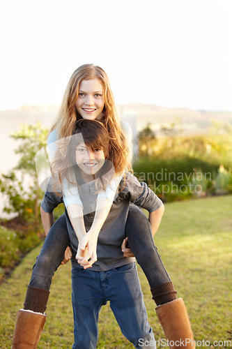 Image of Boy, girl and portrait with piggy ride in the outdoor with happiness or playful summer. Happy, brother and embrace sister in garden with hug or back for bond or love with sunshine on weekend.