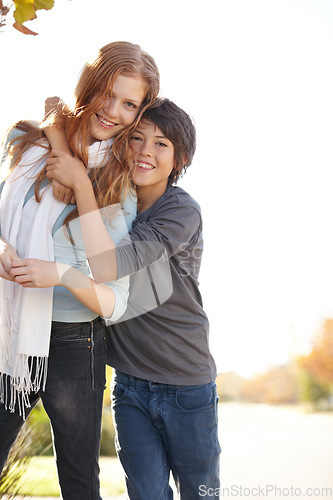 Image of Love, portrait of brother with sister and hug outdoors for support with a lens flare with smile. Care or bonding time, family and happy people hugging outside together for health wellness in nature