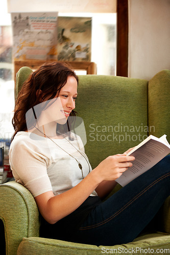 Image of Education, woman reading a book and on sofa sitting with a smile for research. Studying or learning, information or library and happy female person read a textbook or notebook for knowledge.