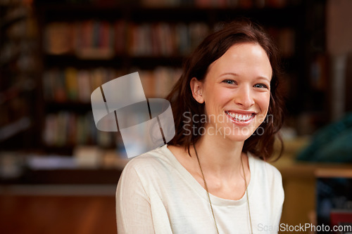 Image of Happy, portrait of woman librarian and in a library with a smile for education. Reading or learning, studying academic or happiness and cheerful female person at a book store looking for books