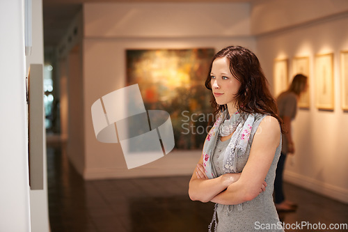 Image of Woman, gallery and thinking at art exhibition, museum or study creative paintings on show in artist studio. Painting on wall, focus and girl studying abstract artwork, culture or buyer in Venice