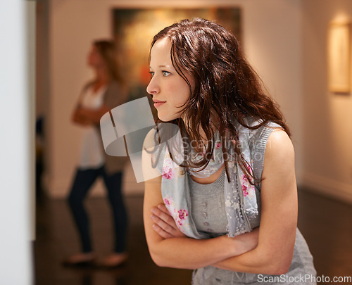 Image of Museum, art and a woman in a painting gallery, looking at photography in creative appreciation. Artistic, design and culture with an attractive young female at an expo or modern artwork exhibition