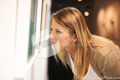 Image of Gallery, woman with art and thinking at exhibition, museum or study creative paintings on show in artist studio. Painting on wall, focus and girl studying abstract artwork, culture or buyer in Venice