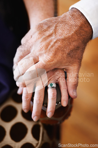 Image of Closeup, holding hands and senior couple with support, empathy and comfort with care, solidarity and loving together. Zoom, fingers and old woman with elderly man, romance or love with trust or grief