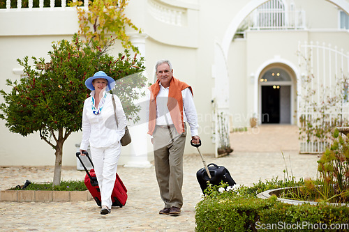 Image of Hotel, vacation and elderly couple walking with suitcase in a holiday location happy in retirement and travel together. Bag, smile and senior people on a journey or man and woman walk in happiness