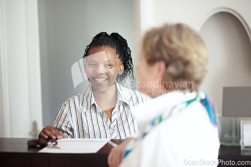 Image of Hotel receptionist, concierge and a black woman helping a senior tourist to check in at a luxury resort. Hospitality, travel or holiday getaway with a happy female secretary in a lodge for assistance