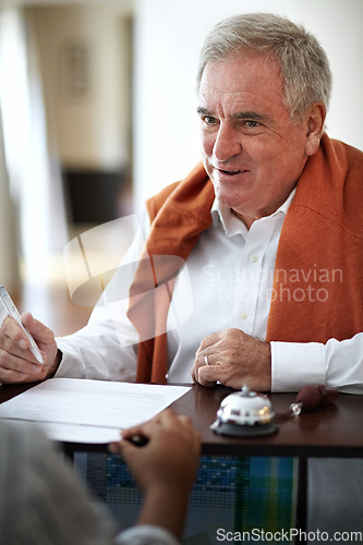 Image of Hotel, reception and an old man signing documents for check in at a luxury hospitality resort for vacation. Paper, signature and travel with a happy senior male tourist in a lodge for holiday travel