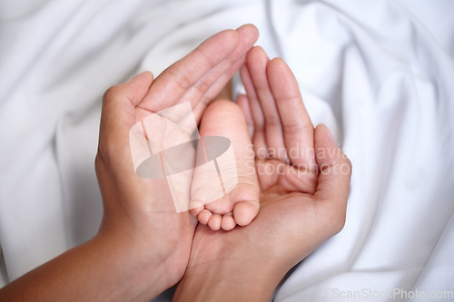 Image of Hands, newborn and closeup of a baby foot with mother holding for care, love and nurture. Childcare, cute and zoom of a woman with her infant child feet in the crib of nursery at their family home.