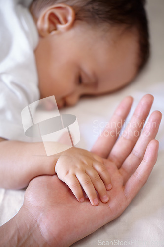 Image of Closeup, hands and baby sleeping, care and nurture with love, support and relaxing with protection. Zoom, fingers and palms with infant, toddler or newborn with mother, asleep and family with comfort