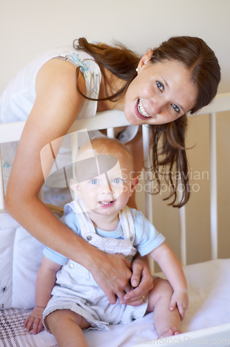 Image of Happy family, portrait of a woman with her baby and in a crib of their home together with a smile. Happiness or development, love or care and mother with her child in a bedroom of their house