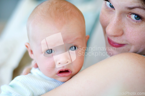 Image of Kid, portrait and mom holding baby, bonding and care together in home. Face, child and mother carrying newborn, infant or young toddler, playing and enjoying quality time with love, family and happy.