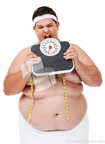 Image of Overweight, scale bite and man upset with diet progress and weight loss goal in studio. White background, hungry and model with plus size stomach with body problem and health issue with towel