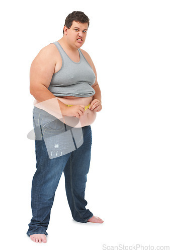 Image of Obesity, tape measure on abdomen and portrait of angry man checking size, body health and isolated on white background. Frustrated male, measuring stomach and weight loss progress on studio backdrop.