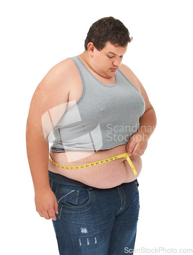 Image of Obesity, tape measure on stomach and man checking waist size, body care and isolated on white background. Male measuring abdomen for weight loss progress, healthcare and motivation on studio backdrop