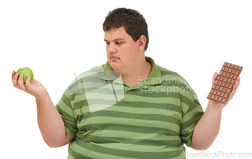 Image of Plus size, diet decision and man with a apple and candy choice thinking about balance. Male model, studio and white background with healthy and chocolate with weight loss and nutrition problem