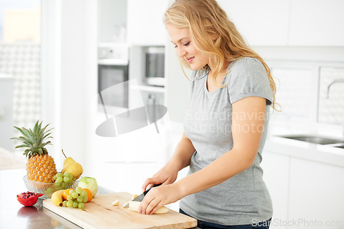 Image of Woman, cooking and fruit for health food and nutrition for weight loss diet and health at home. Kitchen, organic fruits and cut banana in a house with breakfast and nutritionist in the morning