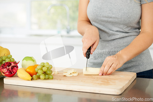 Image of Woman hands, cooking and fruit for health food and nutrition for weight loss diet and health at home. Kitchen, fruits and chopping banana in a house with breakfast and nutritionist in the morning