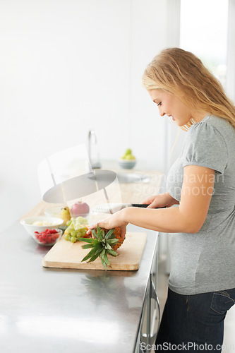 Image of Woman, healthy cooking and fruit for eating food and nutrition for weight loss diet and health at home. Kitchen, cut fruits and produce in a house with breakfast and nutritionist in the morning