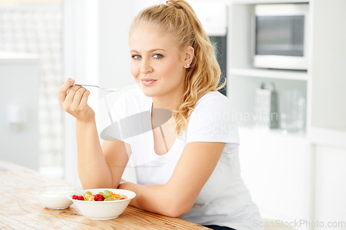 Image of Fruits, morning and portrait of eating woman with healthy lunch or breakfast meal or diet in home kitchen for wellness. Nutrition, health and vegan person smile and happy for salad and self care