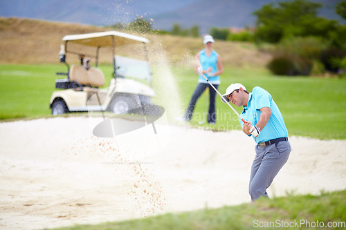 Image of Golf, sports and man or golfer playing sport for fitness, workout and exercise with a swing on a green course. Wellness, person and athlete training in action or outdoor game with a club stroke