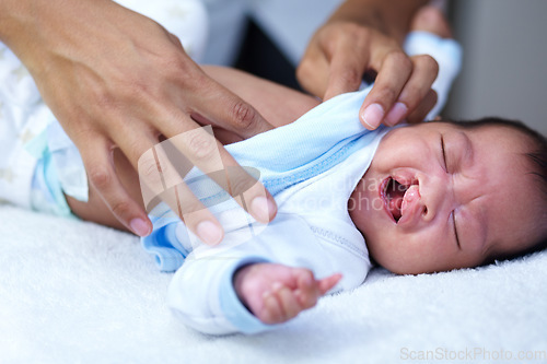 Image of Newborn, cleft palate and mother care for a baby crying in a home bed feeling tired in a bedroom or medical centre. Health, healthcare and young child or kid sad and parent give love and comfort