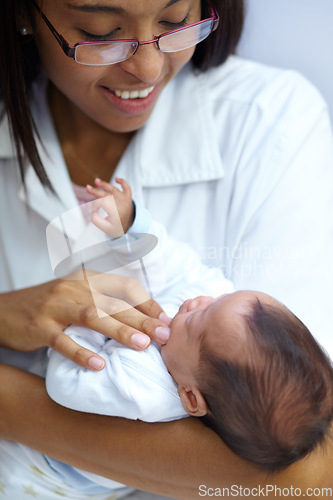 Image of Healthcare, smile and a pediatrician with a baby in the hospital for insurance, care or treatment. Medical, children and a happy doctor woman in glasses holding a newborn infant in a health clinic