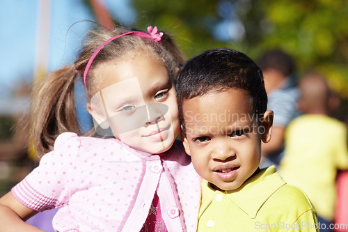 Image of Happy, children and portrait of friends at a park playing outdoor at break time at kindergarten. Happiness, smile and kids embracing and having fun together in nature on the playground at school.