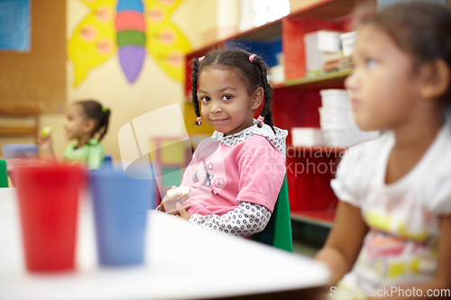 Image of Child, classroom and lunch in portrait with smile for education at a table with children. Break, kids and learning at school with apple in kindergarten with chair or desk with food with friends.