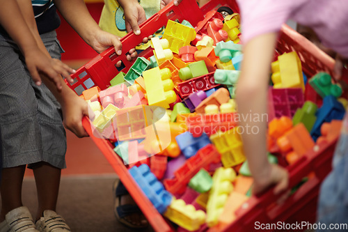 Image of Closeup, hands and kids with plastic blocks, colors and playing with fun, games and education. Zoom, children or young people in a classroom, school and playful with child development, box and creche