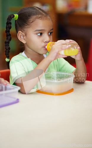 Image of Drink, juice and girl in kindergarten with food for nutrition at school for learning in class . School, drinks and kid at table in classroom with sandwich for an education to learn at creche.