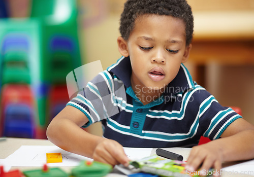 Image of School, focus and a child drawing in a class for education, learning and creativity. Table, creative and a little male student doing art at kindergarten or creche to learn about color and playing