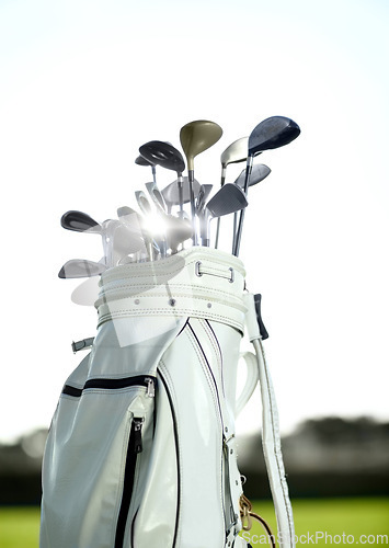 Image of Golf bag, sports and clubs outdoor on course for training, workout or summer sport on green field sunset mockup. Golfer, bags and equipment for game, competition or exercise with blue sky lens flare.