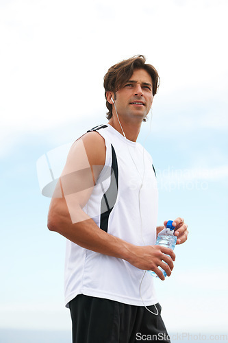 Image of Thinking, running and a man with water and music after a workout, exercise or outdoor cardio. Break, relax and a runner with a drink while listening to a podcast after training or sports in nature