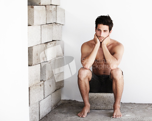 Image of Thinking, sexy man with serious look and wall background with beauty, glow and confidence. Attractive, confident and sensual face of male model on brick backdrop in morning with thoughtful expression