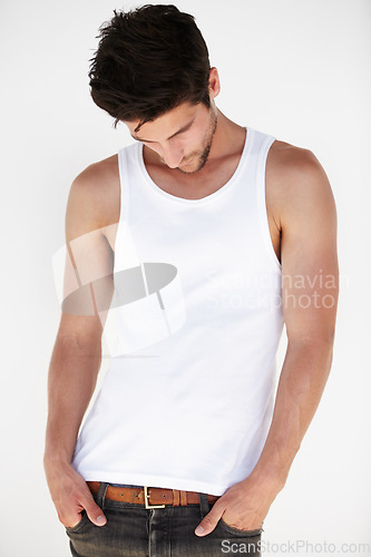 Image of Thinking, casual style and man with white background in a studio with modern fashion. Isolated, male model and vest of a young person with hands in pocket contemplating looking down alone with idea