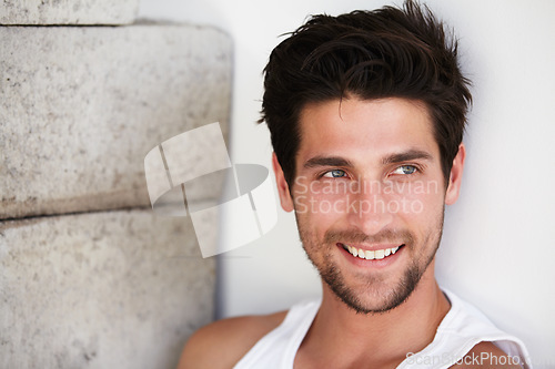 Image of Handsome man with smile, sexy look and wall background with beauty, wellness and confidence. Attractive, confident and health, happy face of male model on brick backdrop in morning with happiness.