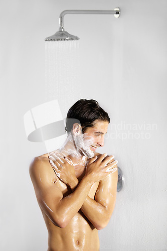 Image of Shower, man and home with body cleaning and soap in the morning in bathroom. Water, young male person and smile with hygiene and clean skin care in a house with cosmetic grooming and shaving foam