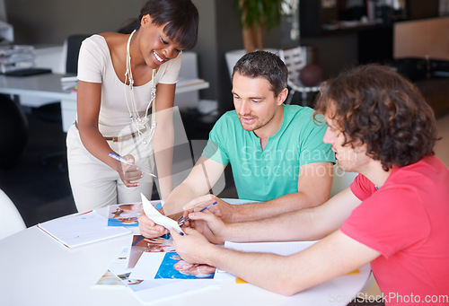 Image of Diversity, colleagues planning and at desk in a modern workplace office together for support. Collaboration or teamwork, ideas or strategy and coworkers brainstorming or planning at workstation