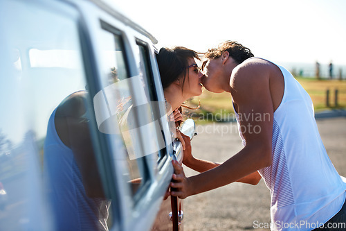 Image of Kiss, love and a couple on a road trip in a van for a holiday, adventure or a drive. Care, romantic and a man and woman kissing in nature with transportation for a honeymoon vacation or date