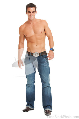 Image of Isolated man, smile and shirtless with jeans for fitness, wellness and health by white background. Young male, bodybuilder and happy for muscle development, growth and fashion in studio portrait