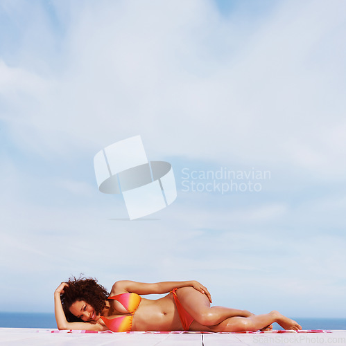 Image of Relax, smile and bikini with black woman at beach for sunbathing, tropical and peace on Brazil vacation. Summer break, sun and blue sky with girl on deck of resort for travel destination and mockup