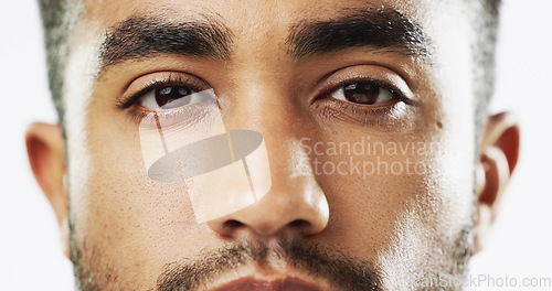Image of Closeup, face and serious man in studio for skincare, confident and handsome against white background. Zoom, young and portrait of Indian male model with wellness, beauty or cosmetic routine isolated