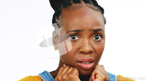 Image of Face, fear and worried with a black woman in studio isolated on a white background looking afraid. Portrait, scared and phobia with a young female feeling alone, helpless or overwhelmed by emotions