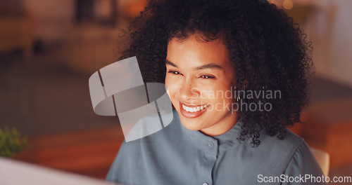 Image of Night, smile and computer with black woman in office for research proposal, project and satisfaction. Internet, technology and idea with employee in agency for information, confident and connection