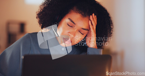 Image of Call center, night and headache with black woman in office for stress, overtime and mental health. Customer service, communication and hotline with employee suffering from pain, tired and burnout